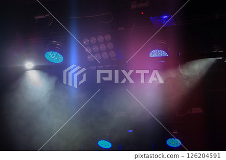 Stage lights with white and blue beams of light. Stage lights with white and blue beams of light. 126204591