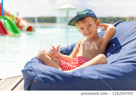 Young Boy Relaxing by the Poolside 126204703