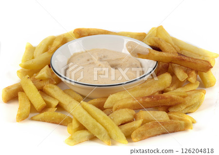 A bowl of fries with white sauce on top. The fries are golden brown and crispy. The bowl is white with a blue rim. 126204818