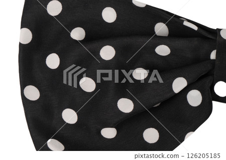 Part of a black bow with white polka dots isolated. Part of a black bow with white polka dots isolated. 126205185