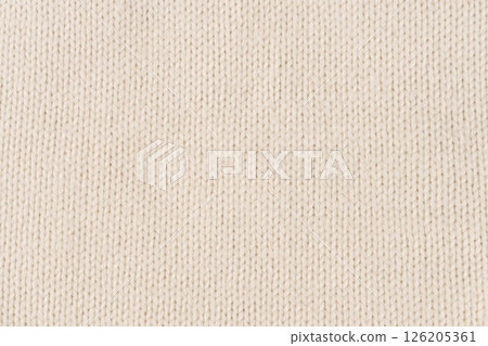 Background made of white knitted fabric. Front surface. 126205361