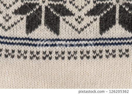 A knitted item with a pattern of squares and triangles 126205362