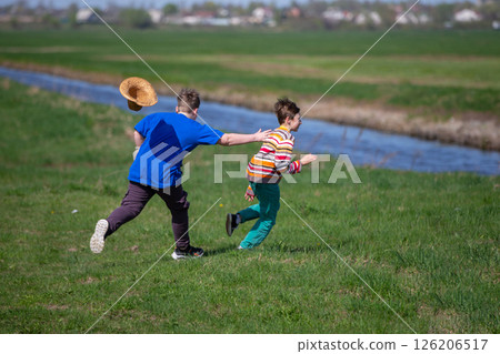 Two boys running after each other in nature. Children on summer holidays. Two boys running after each other in nature. Children on summer holidays. 126206517