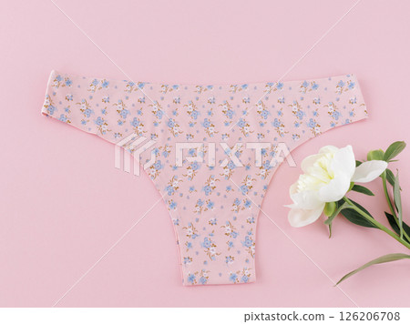 Pink cotton women's panties on the pink background. 126206708