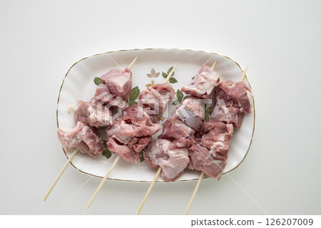 Pork cheeks being prepared 126207009