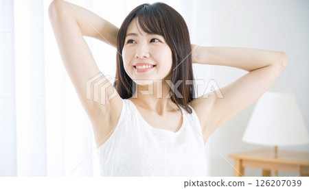 Smiling young woman showing her armpits, beauty and hair removal image 126207039
