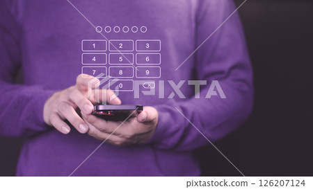 Person holds a smartphone with a digital keypad overlay, entering a passcode for security access. This image represents digital security, PIN entry, and data protection on mobile devices. 126207124