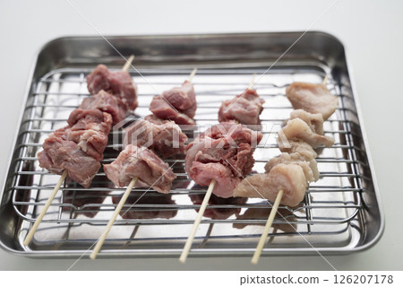 Pork skewers being prepared Pork skewers being prepared 126207178