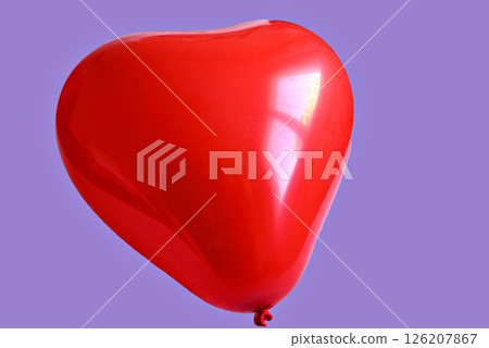 Red heart-shaped balloon on a turquoise background Red heart-shaped balloon on a turquoise background 126207867