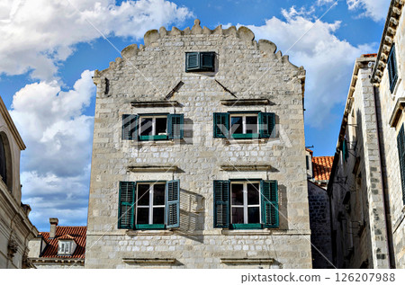 View of the old town of Dubrovnik behind its walls under a blue sky with white clouds, Croatia View of the old town of Dubrovnik behind its walls under a blue sky with white clouds, Croatia 126207988