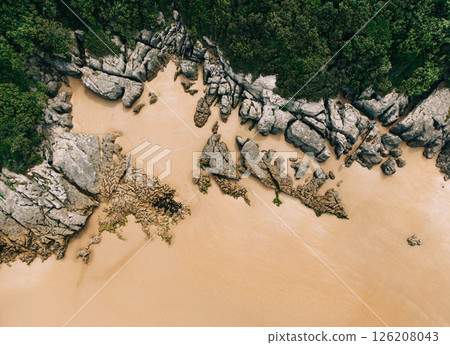 Aerial view of rocky coastline with golden sand Aerial view of rocky coastline with golden sand 126208043