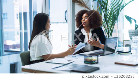 Business women, strategy and team planning in office, discussion or brainstorming insurance policy with paper. Laptop, meeting or conversation with manager for report, risk management or explain idea 126208255