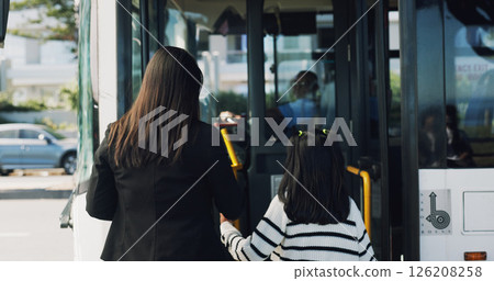 Back, bus stop and mother with girl, travel and morning commute with public transportation. Family, city service and passenger with vehicle trip, boarding station or child with journey, kid or parent 126208258