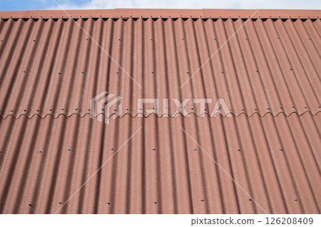 Brown wave shaped metal siding, roofing material Brown wave shaped metal siding, roofing material 126208409