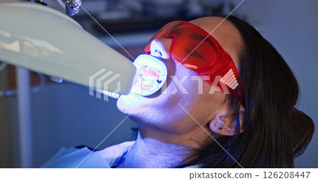 Appointment, mouth and ultraviolet with patient at dentist for checkup, operation or surgery. Dental hygiene, light or teeth whitening with woman at clinic for dentistry, oral healthcare or procedure 126208447
