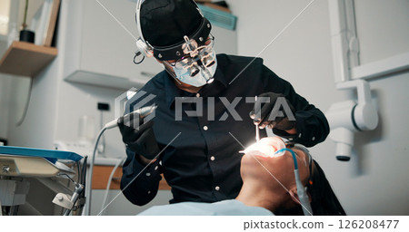 Appointment, medical procedure and patient with dentist in office for checkup or mouth operation. Dental hygiene, healthcare or oral exam with medicine professional and woman at clinic for dentistry 126208477