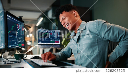 Man, back pain and computer screen with trading, stats and stress for revenue report in office at company. Person, spine injury and burnout at night, graphs and fatigue with stock market at agency Man, back pain and computer screen with trading, stats and stress for revenue report in office at company. Person, spine injury and burnout at night, graphs and fatigue with stock market at agency 126208525