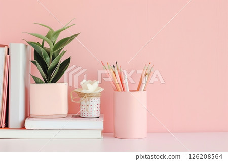 Peach color wall and home office desk with supplies, pencils, pens, boxes, plant pot. Creative stylish minimal workspace. Contemporary flat white work tabletop for product display montage. Blank space 126208564