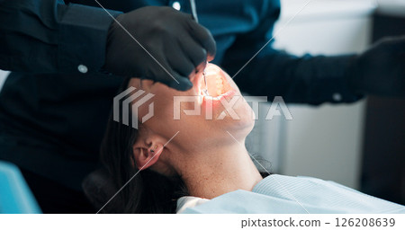 Hands, light and mouth of patient with dentist in office for checkup, operation or surgery. Appointment, dental hygiene or healthcare with medicine professional and woman at clinic for oral exam 126208639