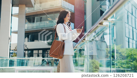 Business woman, city and realtor with phone for corporate building, investment or communication. Female person, real estate agent or travel with mobile smartphone for property on balcony in town Business woman, city and realtor with phone for corporate building, investment or communication. Female person, real estate agent or travel with mobile smartphone for property on balcony in town 126208721
