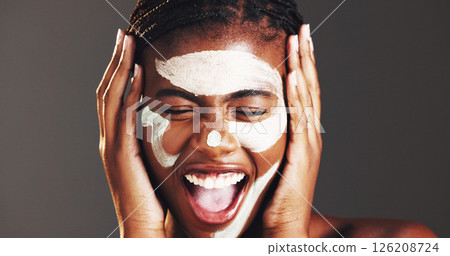 Excited, skincare and clay mask with black woman in studio for facial, spa results success or dermatology. Cosmetics, self care and pore cleaning benefits with person on dark background for happiness 126208724