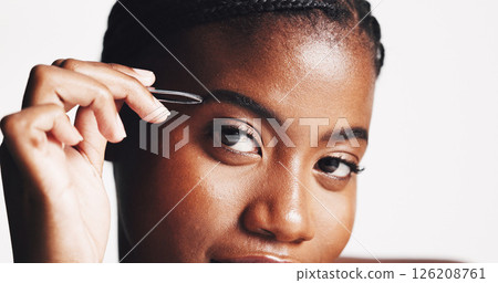 Studio, portrait and woman with tweezer, grooming and plucking eyebrows in morning, beauty or self care. White background, facial treatment and black person with tool for hair removal, shape or Kenya 126208761