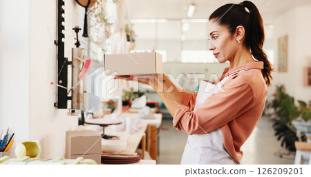 Small business, package and box with woman for order, ceramics and product with shipping inspection. Sale, pottery and startup with packing, shopping and customer parcel for supplier and shipment 126209201