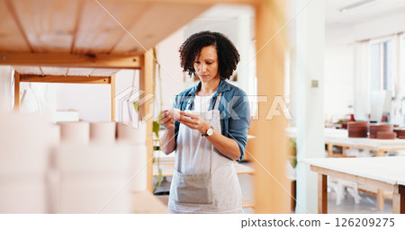 Woman, ceramics and shelf with inspection at store for shape, quality assurance and check for clay product at workshop. Person, design and decision for inventory, results and creativity at studio 126209275