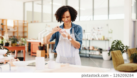 Woman, ceramics and sculpture with thinking at workshop for shape, quality assurance and color for clay product. Person, design and smile with manufacturing process, results and inspection at studio 126209284