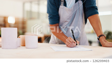 Workshop, hands and inspection with paperwork for pottery, small business and notes for stock management. Closeup, person and potter with document for writing, order information and cups as product 126209403