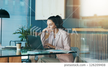 Office, businesswoman and research with laptop for call center, customer information and telemarketing. Workplace, mature person and consultant with headset for online review, sales report or reading 126209408