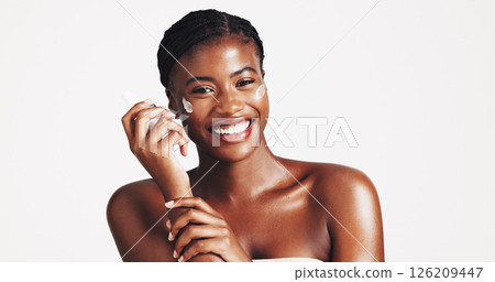 Portrait, skincare and woman with cream, studio and moisturizing of face with lotion, hydration and smile. White background, happy and black person with cosmetics for treatment, glow and smooth skin 126209447