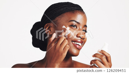 Skincare, cream and woman with product, studio and moisturizing of face with lotion, hydration and smile. White background, happy and black person with cosmetics for treatment, glow and smooth skin Skincare, cream and woman with product, studio and moisturizing of face with lotion, hydration and smile. White background, happy and black person with cosmetics for treatment, glow and smooth skin 126209451