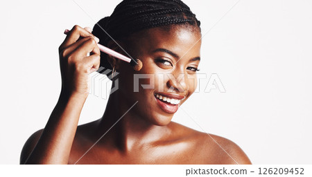 Makeup, brush and portrait of black woman for beauty, cosmetics and glamour on white background. Studio space, cosmetology and African girl model with smile for foundation, skincare and application Makeup, brush and portrait of black woman for beauty, cosmetics and glamour on white background. Studio space, cosmetology and African girl model with smile for foundation, skincare and application 126209452