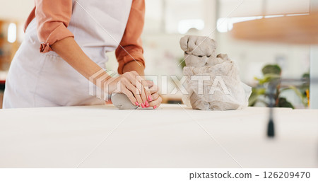 Pottery, art and hands of woman in workshop with clay for design, sculpture and learning skills in studio. Creative, startup and person with ceramic object for DIY hobby, craft and handmade product Pottery, art and hands of woman in workshop with clay for design, sculpture and learning skills in studio. Creative, startup and person with ceramic object for DIY hobby, craft and handmade product 126209470