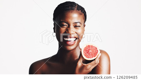Happy, black woman and portrait with grapefruit for detox, vitamin C or skincare on a white studio background. Female person, model or smile with natural organic fruit for facial treatment on space 126209485