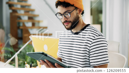 Smile, man and reading on tablet in office for research, schedule update and review newsletter. Male journalist, digital and editing article, story information and feedback for magazine publication 126209555