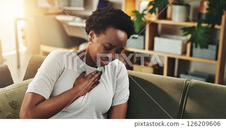 Breathing, chest pain or heartburn with black woman on sofa in living room of home for discomfort. Asthma, emergency or lungs with person in apartment for symptoms of cardiac arrest or tuberculosis Breathing, chest pain or heartburn with black woman on sofa in living room of home for discomfort. Asthma, emergency or lungs with person in apartment for symptoms of cardiac arrest or tuberculosis 126209606