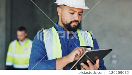 Building, serious and tablet with construction worker man on site for civil engineering or development. App, inspection and planning with developer person on worksite as project management supervisor 126209683