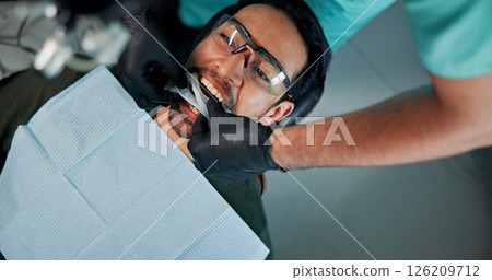 Cleaning, medical procedure and patient with dentist in office for checkup or mouth operation. Healthcare, hygiene or oral exam with man and medicine professional at clinic for dental from above 126209712