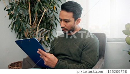 Waiting room, clinic and man with clipboard for writing information, insurance form and medical history. Healthcare, hospital and person with checklist for wellness, appointment and consultation Waiting room, clinic and man with clipboard for writing information, insurance form and medical history. Healthcare, hospital and person with checklist for wellness, appointment and consultation 126209738