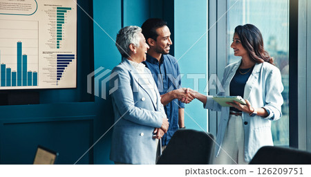 Handshake, tablet and business people in office, conversation and charts for profit growth. Group, shaking hands and employees with tech, B2B deal and financial advisor with partnership and agreement 126209751