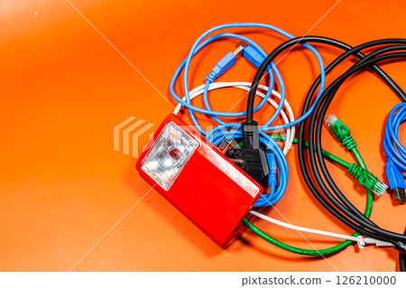 Open lantern with many wires of different colors coming out, on an orange surface Open lantern with many wires of different colors coming out, on an orange surface 126210000