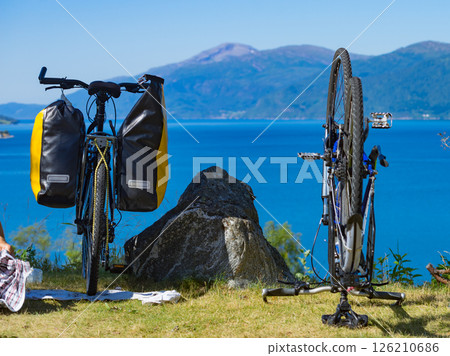 Bike repair against nature fjord, Norway Bike repair against nature fjord, Norway 126210686