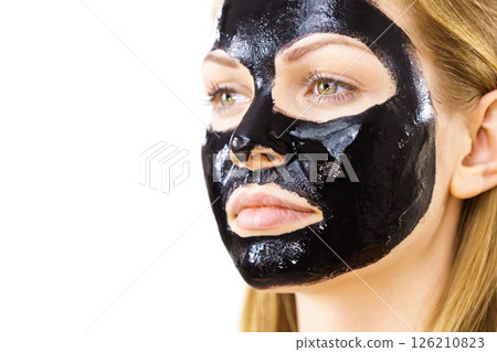 Woman with black peel off mask on face 126210823