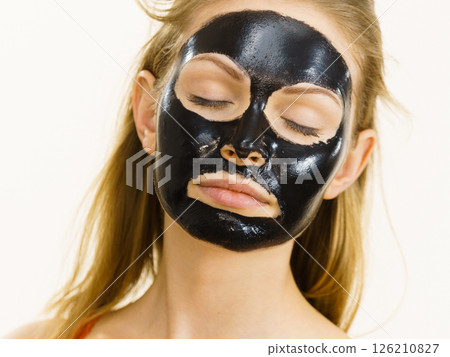 Girl black carbo peel off mask on face Girl black carbo peel off mask on face 126210827
