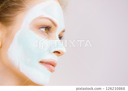 Girl with white green mud mask on face Girl with white green mud mask on face 126210868