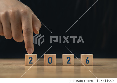 Hand arranging wooden blocks with numbers 2026 on a wooden surface symbolizing the approaching year and new beginnings for future planning and aspirations Hand arranging wooden blocks with numbers 2026 on a wooden surface symbolizing the approaching year and new beginnings for future planning and aspirations 126211092