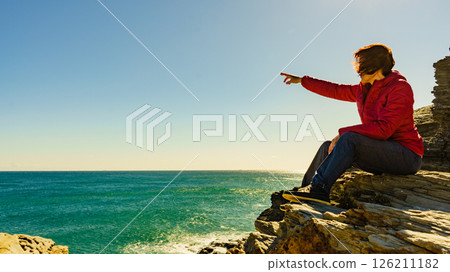 Tourist woman on sea cliffs in Spain 126211182