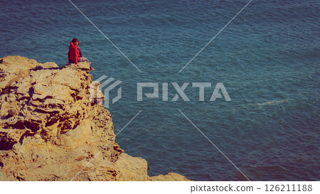 Tourist woman on sea cliffs in Spain 126211188
